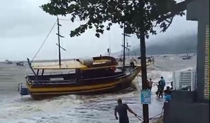 Moradores e pescadores tentam segurar com cordas embarcação turística em Morrinhos (Foto: Reprodução)  